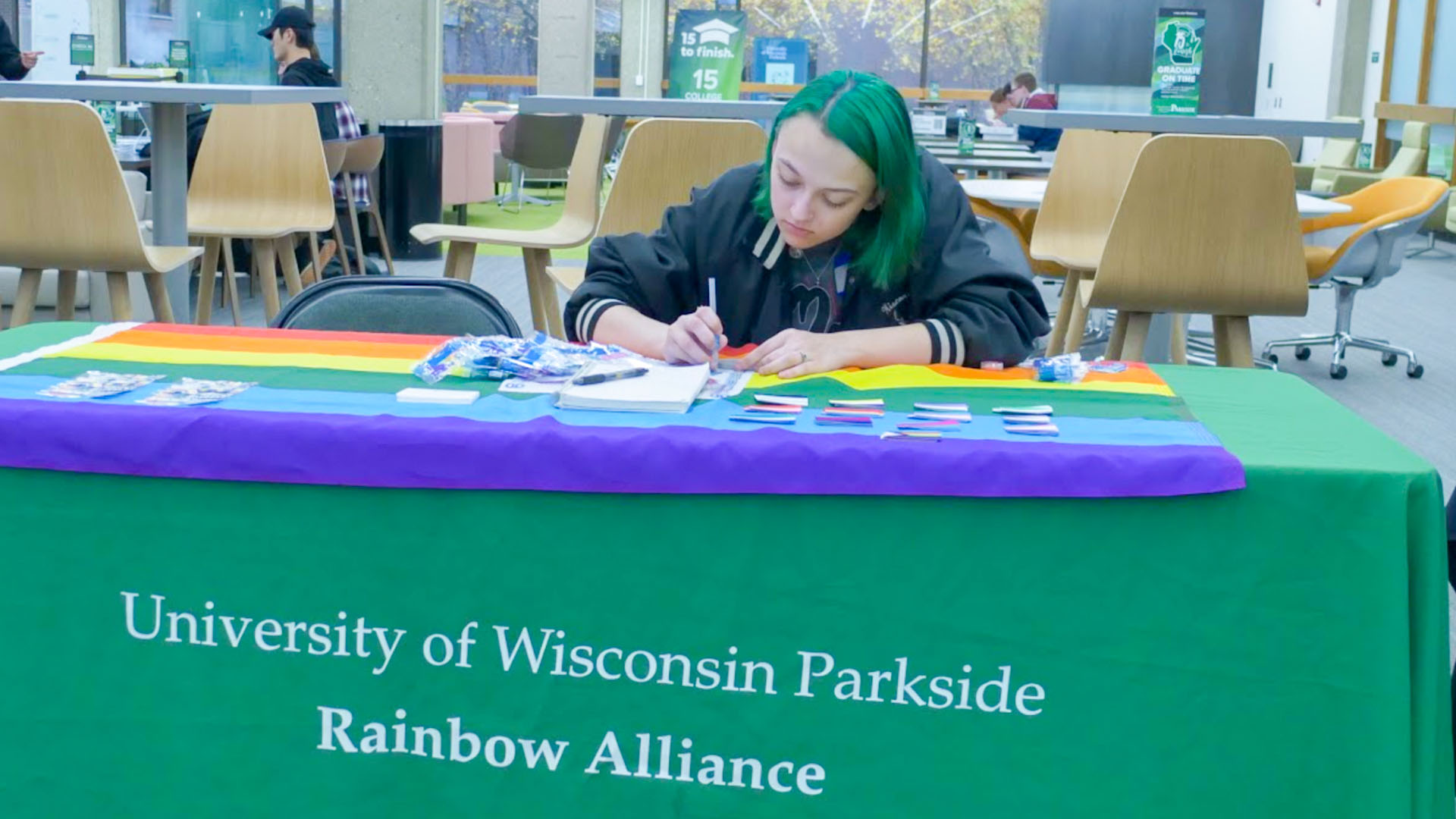 A table showcasing the Rainbow Alliance, an organization based around supporting and uplifting members of the LGBTQ community.