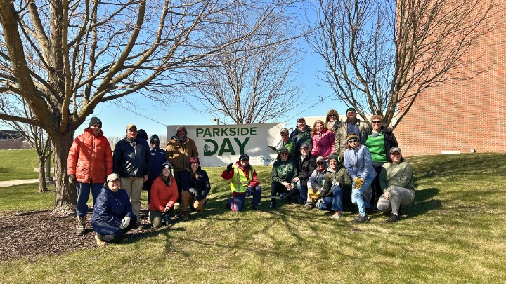 Group of volunteers posing with Parkside Day sign