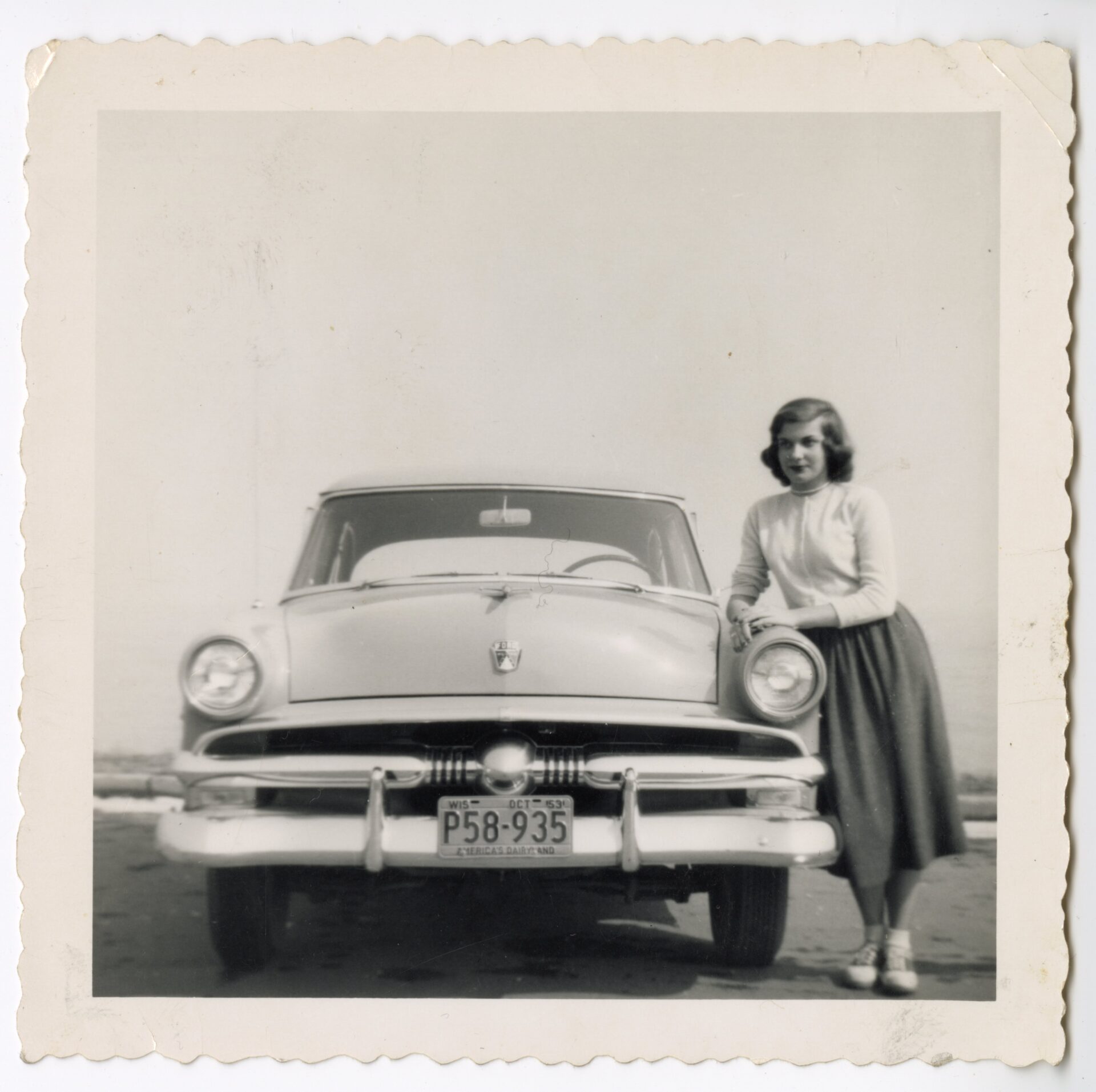 Woman standing next to car